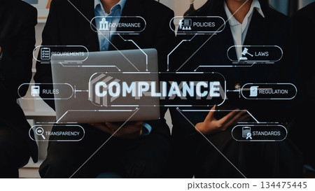 Business professionals discussing compliance concepts with laptop and infographic showing requirements, rules, regulations, policies, and governance strategies. Raster 134475445