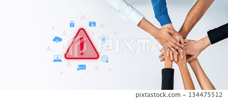 Collaboration and Teamwork Concept with Supportive Hands Stacking Together Around Warning Symbol Representing Alerts in Digital Security Trope 134475512