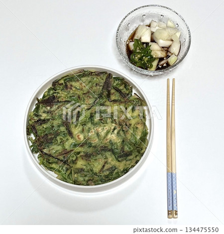 Crispy buchu jeon, Korean chive pancakes, lightly fried to perfection. Filled with fresh chives and a savory batter, they make a flavorful and satisfying snack or side dish. 134475550