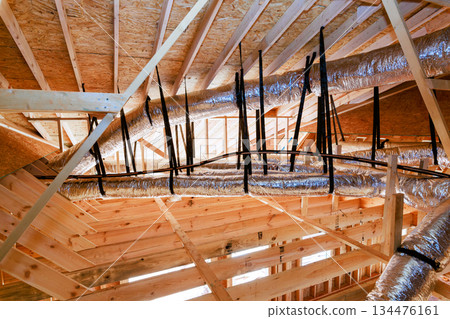 Construction of building with exposed metal ducts wooden beams in ceiling Construction of building with exposed metal ducts wooden beams in ceiling 134476161