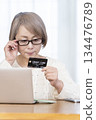 Senior woman enjoying online shopping on a computer 134476789