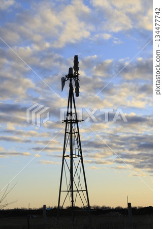 Kansas Farm Windmill out in the country with clouds  134477742