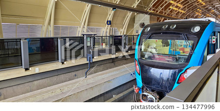 Light Rail Transit or LRT or rail transport system in Indonesia, modern metro train stationed at an urban platform, showcasing efficient public transport 134477996