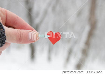 Creative winter background with blue paper heart. Creative winter background with blue paper heart. 134479654