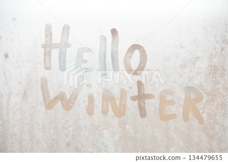 Holiday winter greeting with text hello winter. New Year's eve concept. Holiday winter greeting with text hello winter. New Year's eve concept. 134479655