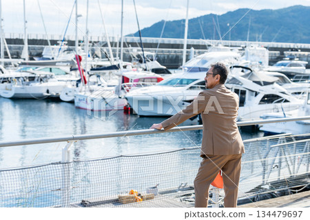 A senior man watching a yacht. Photo courtesy of Ito Marine Town Roadside Station. A senior man watching a yacht. Photo courtesy of Ito Marine Town Roadside Station. 134479697