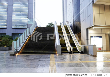Outdoor escalators installed between commercial buildings Outdoor escalators installed between commercial buildings 134480123