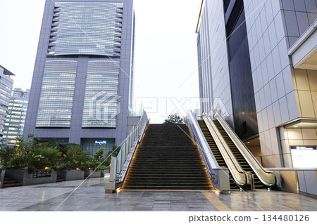 Outdoor escalators installed between commercial buildings 134480126