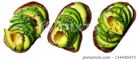 California avocado toast topped with ripe avocado slices, boiled egg, sesame seeds, herbs and sauce, isolated on white background 134480473