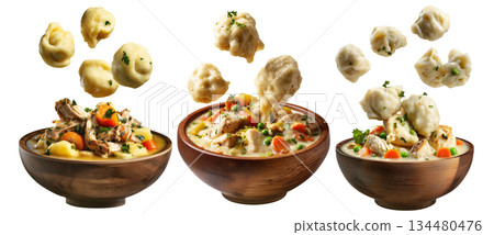 Hearty chicken and dumplings soup with peas and carrots in wooden bowl, floating dumplings, isolated on white background 134480476