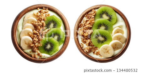 Wooden bowl filled with yogurt or smoothie, sliced kiwi, banana, granola, chia seeds, and fresh mint leaves 134480532