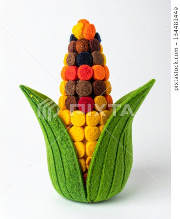 Colorful Felt Corn Cob Decoration with Green Husks on White Background 134481449