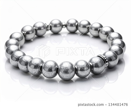 Silver Beaded Bracelet on Reflective Surface against White Background 134481476