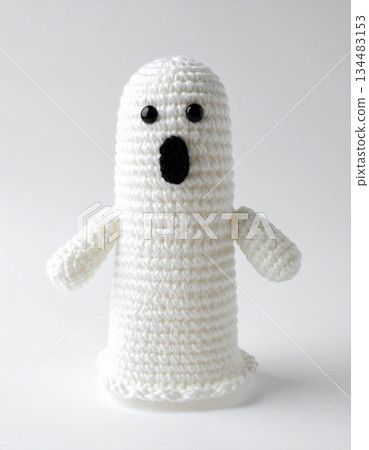 Handmade White Knitted Ghost with Black Oval Mouth on White Background High Key Lighting 134483153