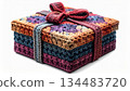Colorful Knitted Gift Box with Bow on White Background Studio Shot 134483720
