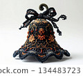 Ornate Black and Copper Beaded Bell Decoration with Bow on White Backdrop 134483723