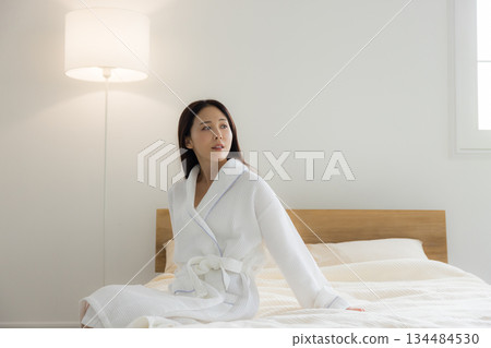 A woman relaxing at bed A woman relaxing at bed 134484530