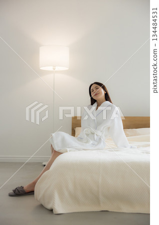 A woman relaxing at bed A woman relaxing at bed 134484531