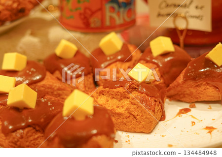 Sweet Scones Drizzled with Caramel Sauce and Topped with Cube Butter Sweet Scones Drizzled with Caramel Sauce and Topped with Cube Butter 134484948