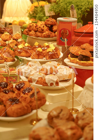 Buffet Table with an Abundant Display of Various Scones and Baked Goods Buffet Table with an Abundant Display of Various Scones and Baked Goods 134484950