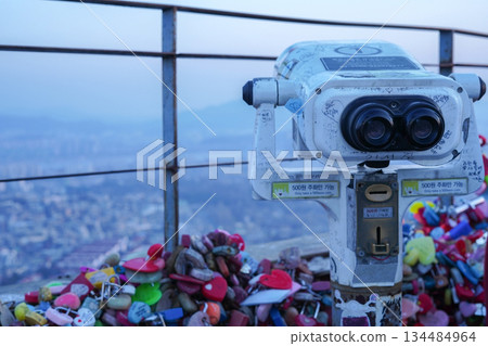 Viewing the Seoul City Panorama Through the Telescope at Namsan Tower Observatory Viewing the Seoul City Panorama Through the Telescope at Namsan Tower Observatory 134484964