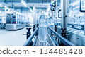 Bottled water on conveyor belt in modern production facility, showcasing automated machinery and clean industrial environment for beverage manufacturing 134485428