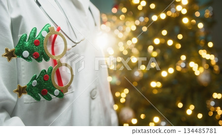 Ophthalmologist Doctor Wishes His Patients a Merry Christmas in Front of Tree Ophthalmologist Doctor Wishes His Patients a Merry Christmas in Front of Tree 134485781