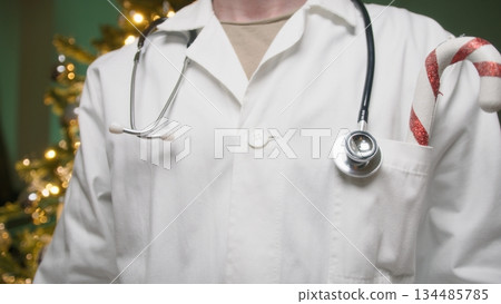 Anonymous Doctor With Coat In Front Of Christmas Tree In Hospital Anonymous Doctor With Coat In Front Of Christmas Tree In Hospital 134485785