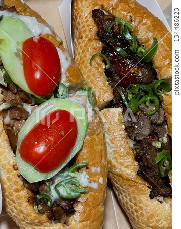 Delicious sandwich filled with fresh ingredients like crisp vegetables, tender meats, and savory spreads, all between two slices of soft bread. Perfect for a quick and satisfying meal. 134486223