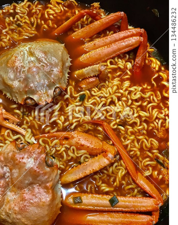 Kkotgae Ramyeon, a spicy crab ramen dish with rich seafood broth, tender noodles, and fresh vegetables. A hearty and flavorful Korean comfort food. Kkotgae Ramyeon, a spicy crab ramen dish with rich seafood broth, tender noodles, and fresh vegetables. A hearty and flavorful Korean comfort food. 134486232