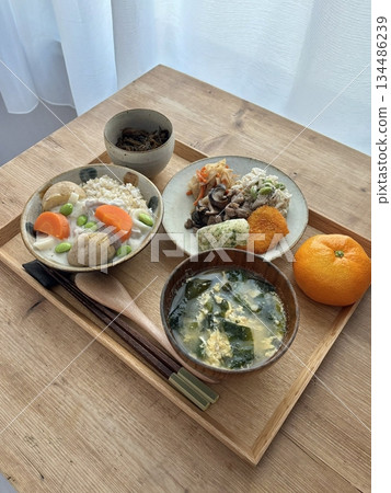 Warm and comforting jibbap (home-cooked Korean meal) with a spread of rice, soup, and banchan, offering a perfect harmony of flavor, tradition, and heartwarming nourishment in every bite. 134486239
