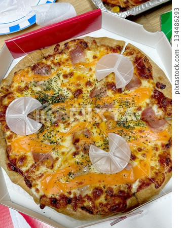 A delicious pizza with a golden crust, melted cheese, and savory toppings. Perfect for food-related designs, menus, or Italian-themed projects, capturing the essence of a classic comfort dish. 134486293