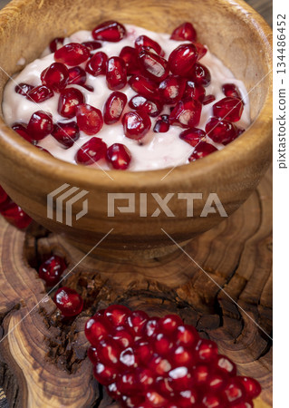 fresh yogurt and ripe red pomegranate seeds, delicious pomegranate-flavored yogurt and fresh ripe red pomegranate fresh yogurt and ripe red pomegranate seeds, delicious pomegranate-flavored yogurt and fresh ripe red pomegranate 134486452