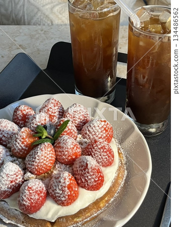 Crispy, golden waffles topped with creamy ice cream, creating a perfect balance of warm and cold, crunchy and smooth. A delightful dessert or breakfast treat, with toppings like fruits or syrup. 134486562