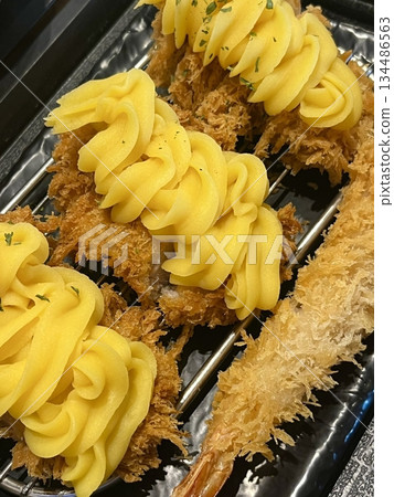 Crispy tonkatsu, a Japanese-style breaded and deep-fried pork cutlet, served with shredded cabbage and drizzled with savory sauce. A delightful balance of crunchy texture and juicy meat. Crispy tonkatsu, a Japanese-style breaded and deep-fried pork cutlet, served with shredded cabbage and drizzled with savory sauce. A delightful balance of crunchy texture and juicy meat. 134486563