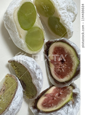 Mochi is a Japanese cake made from glutinous rice, pounded until it is soft and sticky, then shaped into a round shape. Various colors of mochi cake, traditional Japanese food 134486684