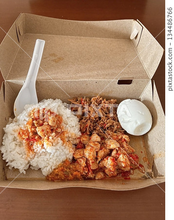 Nasi campur, a classic Indonesian dish featuring rice with an assortment of flavorful sides like fried chicken, sambal, vegetables, and tempeh. A vibrant, balanced meal celebrating Indonesian flavors. Nasi campur, a classic Indonesian dish featuring rice with an assortment of flavorful sides like fried chicken, sambal, vegetables, and tempeh. A vibrant, balanced meal celebrating Indonesian flavors. 134486766