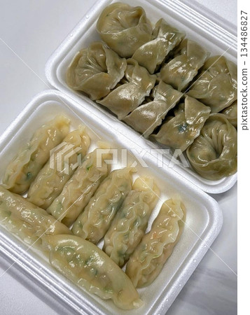 Korean dumplings filled with a mix of savory ingredients like ground meat, tofu, and vegetables. Mandu can be steamed, boiled, or pan-fried, making it a versatile and delicious snack or meal. 134486827