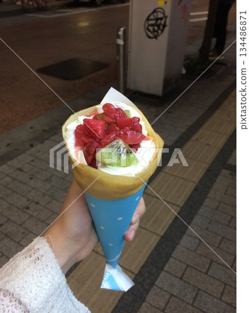 Thin crepes with soft, golden surface and slightly crisp edges, folded neatly to showcase their delicate texture, warm color, and light airy appearance in close-up detail 134486871