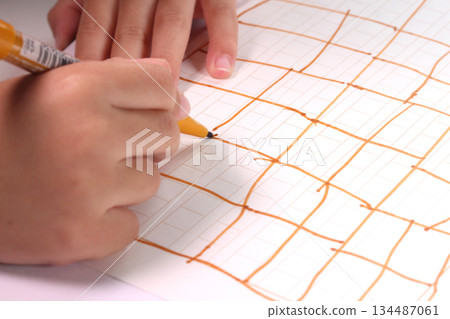 Child's hand drawing a line 134487061