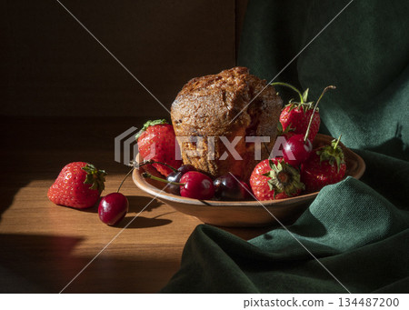 Rustic Fruit Cake With Strawberries and Cherries On Plate Under Warm Lighting 134487200