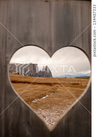 Heart shaped frame with alpine landscape in Dolomites mountains 134487333