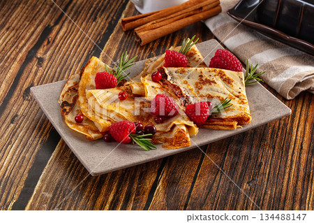 Sweet homemade pancakes with raspberry Sweet homemade pancakes with raspberry 134488147