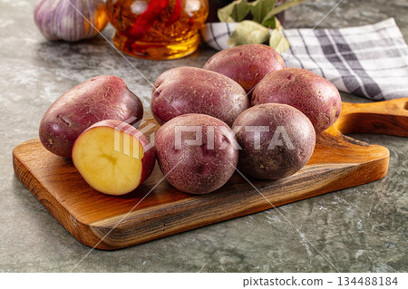 Raw red organic potato over board 134488184