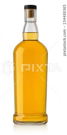 Whiskey bottle with cork stopper containing golden liquor Whiskey bottle with cork stopper containing golden liquor 134488365