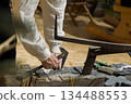 Berlin, Germany - January 22, 2024: Craftsman using tools on wooden workbench in workshop 134488553