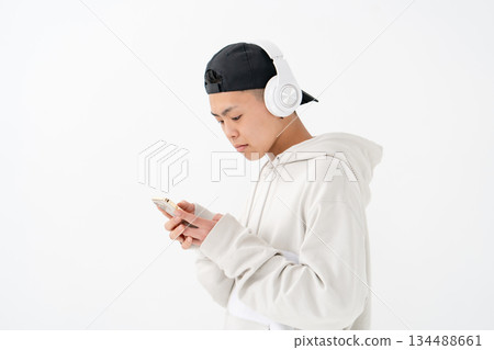 Male teenager portrait headphones smartphone Male teenager portrait headphones smartphone 134488661