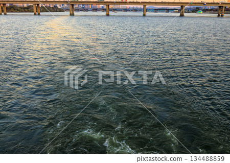 View of the Han River at dusk from a sunset cruise ship View of the Han River at dusk from a sunset cruise ship 134488859