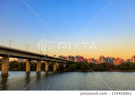 View of the Han River at dusk from a sunset cruise ship View of the Han River at dusk from a sunset cruise ship 134488861