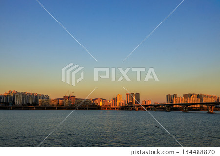 View of the Han River at dusk from a sunset cruise ship View of the Han River at dusk from a sunset cruise ship 134488870